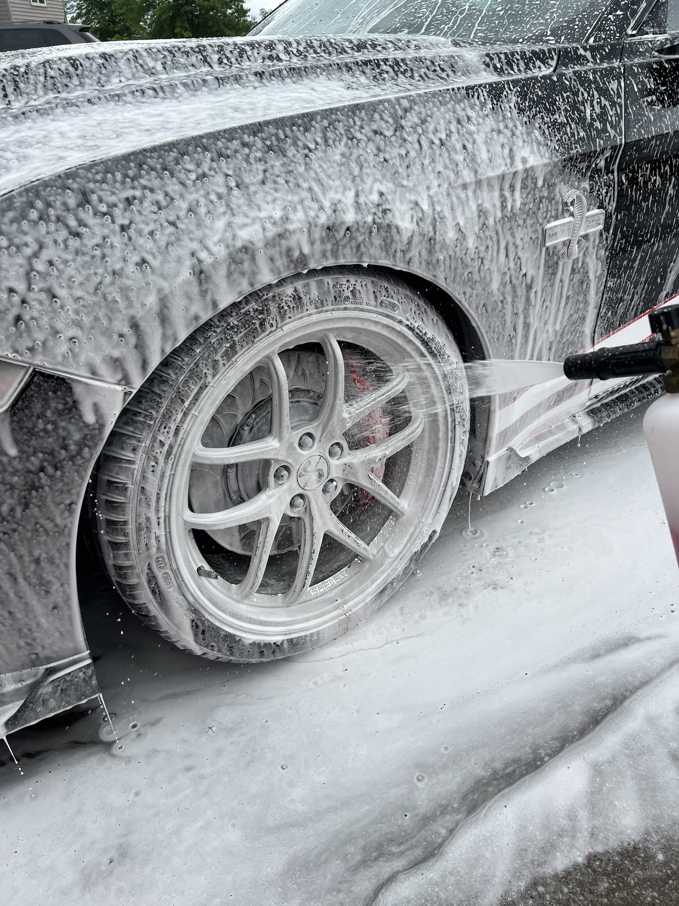 Wheel being cleaned during foam wash